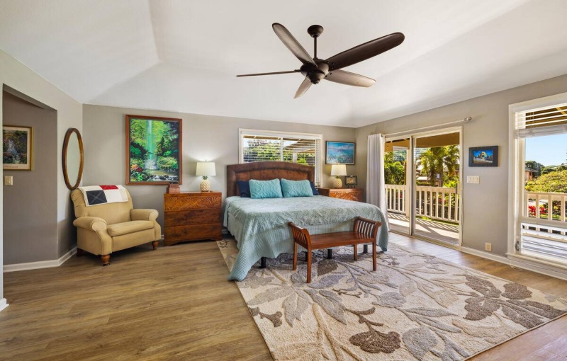 Spacious primary bedroom with vaulted ceiling access to covered lanai